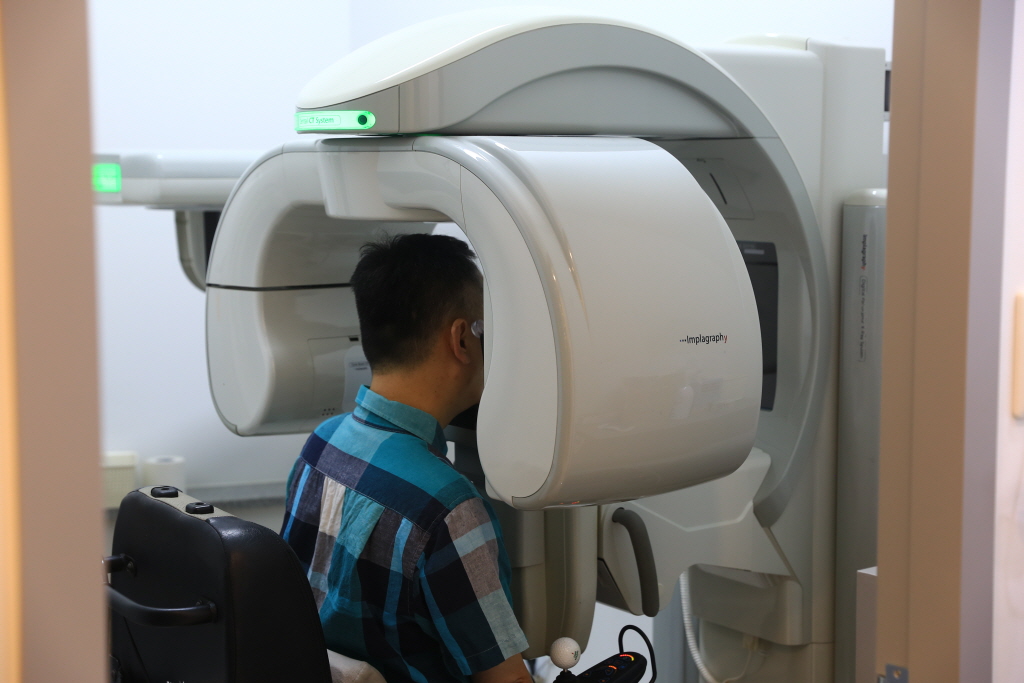 사업에 참여하는 이용고객이 치과 x-레이 촬영 장비를 통해 치아 건강 상태를 점검하고 있는 모습